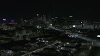 5.7K stock footage aerial video flying by the skyline at night and descend, Downtown Detroit, Michigan Aerial Stock Footage | DX0002_193_027
