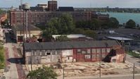 5.7K stock footage aerial video ascend by an abandoned factory building in Detroit, Michigan Aerial Stock Footage | DX0002_194_021