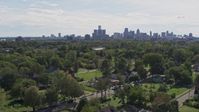 5.7K stock footage aerial video of the distant skyline seen from the Heidelberg Project outdoor art display and urban homes, Detroit, Michigan Aerial Stock Footage | DX0002_195_010