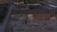5.7K stock footage aerial video descend by abandoned factory building at sunset, Detroit, Michigan Aerial Stock Footage | DX0002_197_016