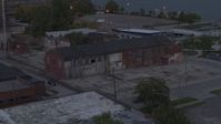 5.7K stock footage aerial video of orbiting an abandoned brick building at sunset, Detroit, Michigan Aerial Stock Footage | DX0002_197_049