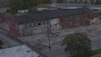 5.7K stock footage aerial video orbit an abandoned brick building at sunset, Detroit, Michigan Aerial Stock Footage | DX0002_197_050