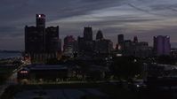 5.7K stock footage aerial video ascend and approach tall skyscrapers at twilight in Downtown Detroit, Michigan Aerial Stock Footage | DX0002_198_018