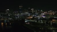 5.7K stock footage aerial video approach the skyline from river and parking lots at night, Downtown Buffalo, New York Aerial Stock Footage | DX0002_205_013