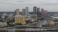 5.7K stock footage aerial video of the skyline seen while passing bridges and channel, Downtown Tampa, Florida Aerial Stock Footage | DX0003_230_007