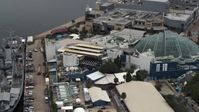5.7K stock footage aerial video reverse view of a warship museum and aquarium in Tampa, Florida Aerial Stock Footage | DX0003_230_030
