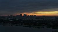 5.7K stock footage aerial video ascend over McKay Bay while focused on the Downtown Tampa skyline at sunset, Florida Aerial Stock Footage | DX0003_231_047