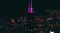 HD stock footage aerial video of spires atop Willis Tower skyscraper, lit purple at night, Downtown Chicago, Illinois Aerial Stock Footage | ED01_098