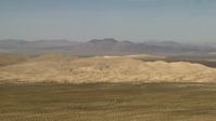 4K stock footage aerial video of Mojave Desert hills and mountains in the background in San Bernardino County, California Aerial Stock Footage | FG0001_000051