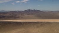 4K stock footage aerial video of a dry lake near Mojave Desert mountains in San Bernardino County, California Aerial Stock Footage | FG0001_000059