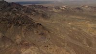 4K stock footage aerial video tilt from Mojave Desert mountains to reveal Pisgah Crater in San Bernardino County, California Aerial Stock Footage | FG0001_000078