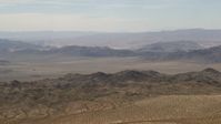 4K stock footage aerial video of passing Iron Ridge mountains and small ranges in the Mojave Desert, San Bernardino County, California Aerial Stock Footage | FG0001_000109