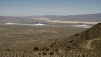 4K stock footage aerial video of towers and arrays of the Ivanpah Solar Electric Generating System, California, eclipsed by mountain Aerial Stock Footage | FG0001_000165