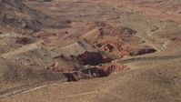 4K stock footage aerial video of sheer red slopes of rocky hills around a shallow box canyon in the Nevada Desert Aerial Stock Footage | FG0001_000253