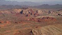4K stock footage aerial video of red rock formations near a mountain ridge in the Nevada Desert Aerial Stock Footage | FG0001_000258