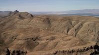 4K stock footage aerial video of steep-sloped mountain ridges in the Nevada Desert and Lake Mead in the background Aerial Stock Footage | FG0001_000261