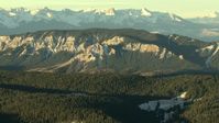 HD stock footage aerial video of a reverse view of mountain ridges with snow at sunrise, Rocky Mountains, Colorado Aerial Stock Footage | HDA13_408