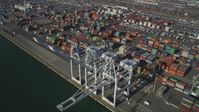 5K stock footage aerial video of flying by shipping containers, cargo cranes at Port of Oakland, California Aerial Stock Footage | JDC02_011