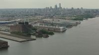 HD stock footage aerial video flyby piers and riverfront factory with a view of the Downtown Philadelphia skyline, Pennsylvania Aerial Stock Footage | PP003_089