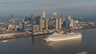 4K stock footage aerial video orbit a Carnival Cruise ship sailing by Downtown New Orleans at sunrise, Louisiana Aerial Stock Footage | PVED01_037