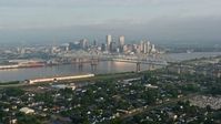 4K stock footage aerial video wide orbit of Crescent City Connection and Downtown New Orleans at sunrise seen from Gretna, Louisiana Aerial Stock Footage | PVED01_045