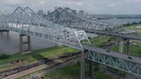 4K stock footage aerial video flyby Crescent City Connection Bridge and reveal Downtown New Orleans skyline, Louisiana Aerial Stock Footage | PVED01_113