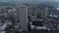 4K stock footage aerial video tilt to reveal and fly over Downtown New Orleans skyscrapers toward French Quarter, Louisiana Aerial Stock Footage | PVED01_140