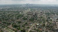 4K stock footage aerial video tilt from Uptown suburbs to reveal Downtown New Orleans skyline, Louisiana Aerial Stock Footage | PVED01_154