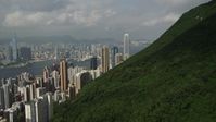 5K stock footage aerial video approach Hong Kong Island skyscrapers seen from a green mountain in China Aerial Stock Footage | SS01_0035