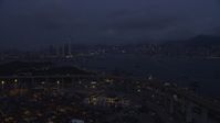 5K stock footage aerial video fly over Port of Hong Kong to approach Kowloon and Hong Kong Island at night, China Aerial Stock Footage | SS01_0119