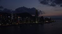 5K stock footage aerial video of Hong Kong Island skyline seen from Victoria Harbor at nighttime, China Aerial Stock Footage | SS01_0144