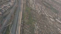 4K stock footage aerial video pan across I-105 and I-710 interchange by Los Angeles River in Downey, reveal Lynwood suburbs, California Aerial Stock Footage | WA003_023