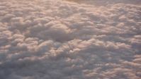 4K stock footage aerial video flyby sunset-lit clouds and tilt to the clouds below in Southern California Aerial Stock Footage | WA005_007