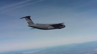 4K stock footage aerial video tilt to reveal a Lockheed C-5 flying over hills in Northern California Aerial Stock Footage | WAAF01_C012_0117G5
