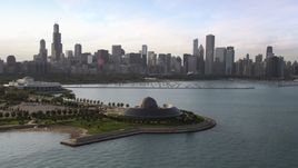 The Adler Planetarium and Astronomy Museum with the Downtown Chicago skyline and harbor in background, Illinois Aerial Stock Photos | AX0002_086.0000203F