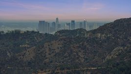 Downtown Los Angeles seen from behind a hill, twilight, California Aerial Stock Photos | AX0158_004.0000052