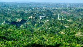 Arecibo Observatory rising above the lush green Karst Forest, Puerto Rico  Aerial Stock Photos | AX101_087.0000000F