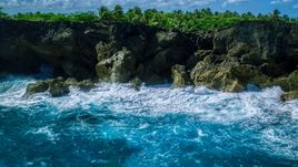 Coastal rock formations and caves, and crashing ocean waves in Arecibo, Puerto Rico  Aerial Stock Photos | AX101_163.0000000F