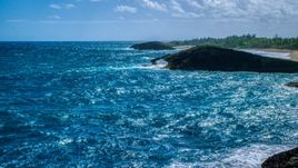 Domed rock formation in crystal blue waters, Arecibo, Puerto Rico Aerial Stock Photos | AX101_169.0000312F