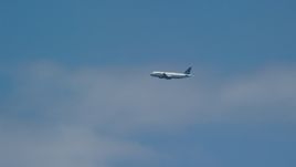 A passenger plane and blue skies, Carolina, Puerto Rico Aerial Stock Photos | AX102_014.0000199F