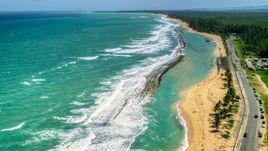 Waves rolling toward the beach and highway, Loiza, Puerto Rico Aerial Stock Photos | AX102_018.0000143F