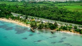Highway and beachfront shops and restaurants in Luquillo, Puerto Rico  Aerial Stock Photos | AX102_048.0000000F
