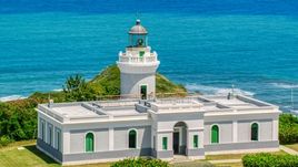 Cape San Juan Light looking out on to crystal blue waters, Puerto Rico Aerial Stock Photos | AX102_066.0000000F