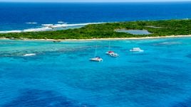 Catamarans in tropical blue waters near reefs and an island, Rada Fajardo, Puerto Rico Aerial Stock Photos | AX102_074.0000000F