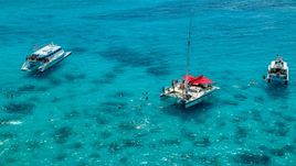 Snorkelers and catamarans in tropical blue waters, Rada Fajardo, Puerto Rico Aerial Stock Photos | AX102_078.0000040F