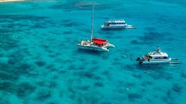 Three catamarans in clear blue water, Rada Fajardo, Puerto Rico  Aerial Stock Photos | AX102_079.0000055F