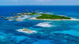 A green island surrounded by smaller rocky islands and tropical blue waters, Puerto Rico  Aerial Stock Photos | AX102_088.0000259F