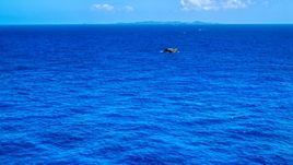 Tiny rocky island in sapphire blue ocean, Puerto Rico  Aerial Stock Photos | AX102_090.0000165F