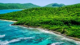 Blue ocean waters and a green island coastline in Culebra, Puerto Rico  Aerial Stock Photos | AX102_111.0000000F