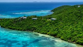 Oceanfront homes and trees overlooking sapphire blue waters, Culebra, Puerto Rico  Aerial Stock Photos | AX102_137.0000000F